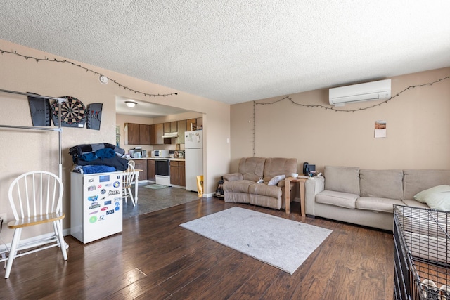 living room with dark hardwood / wood-style floors, a textured ceiling, and a wall unit AC