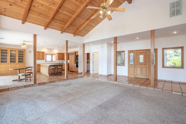 unfurnished living room with beam ceiling, light tile patterned flooring, high vaulted ceiling, wooden ceiling, and ceiling fan