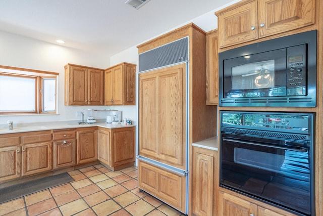 kitchen featuring black appliances and light tile patterned floors