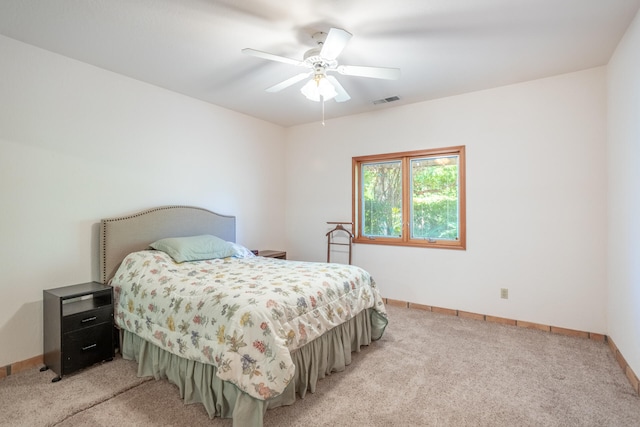 bedroom with light colored carpet and ceiling fan