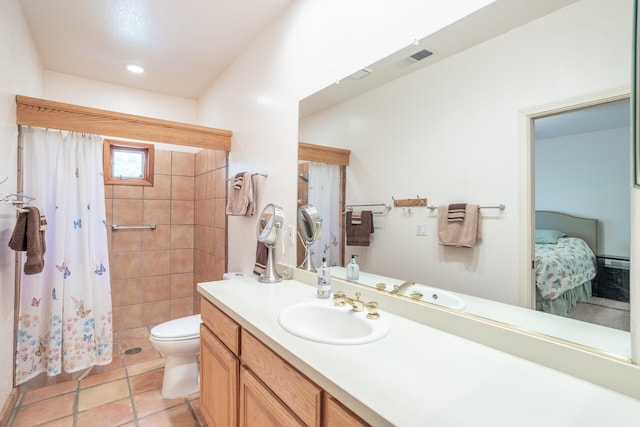 bathroom featuring tile patterned floors, toilet, and vanity