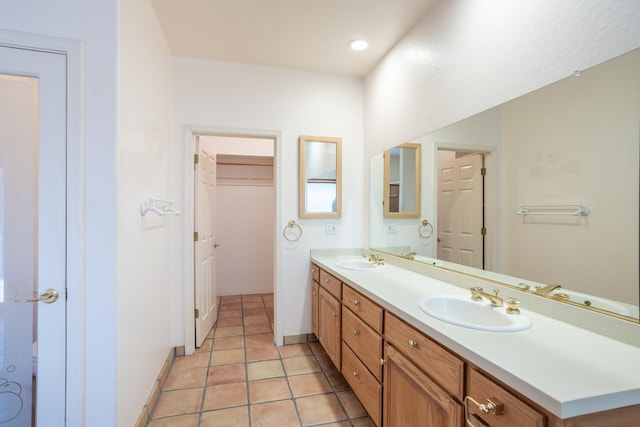 bathroom with tile patterned floors and double sink vanity