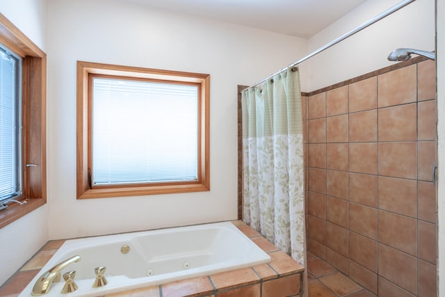 bathroom featuring tiled tub and tile patterned floors