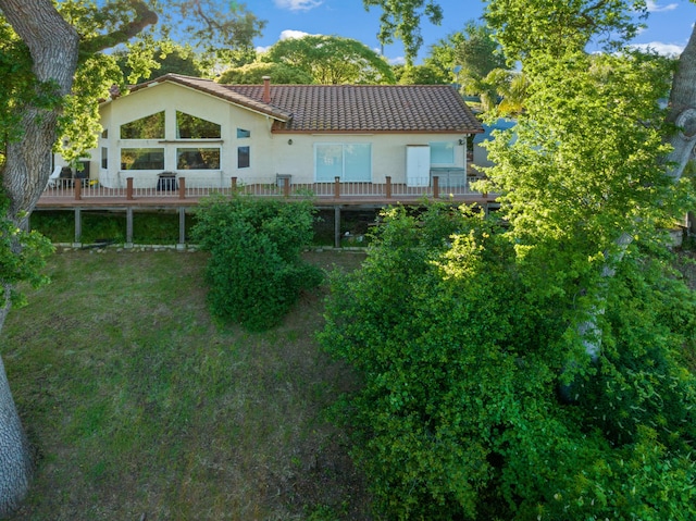 back of house with a yard and a wooden deck