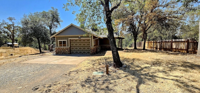 exterior space with a garage, concrete driveway, and fence