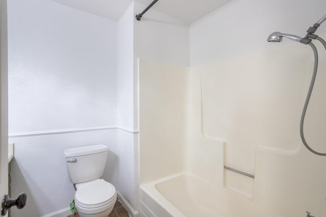 bathroom with tile patterned flooring, toilet, and baseboards