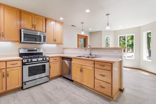 kitchen with light tile patterned floors, kitchen peninsula, stainless steel appliances, decorative light fixtures, and sink