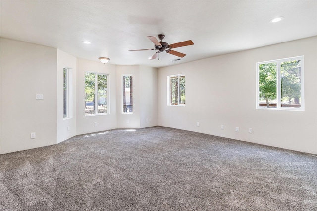 carpeted empty room featuring ceiling fan