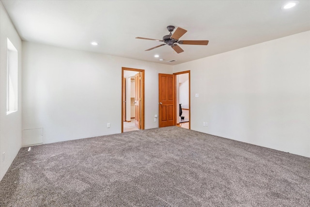 spare room with carpet and ceiling fan