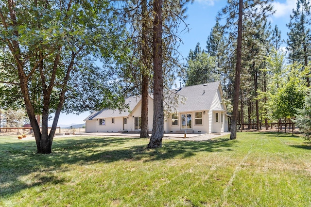 rear view of property with a lawn