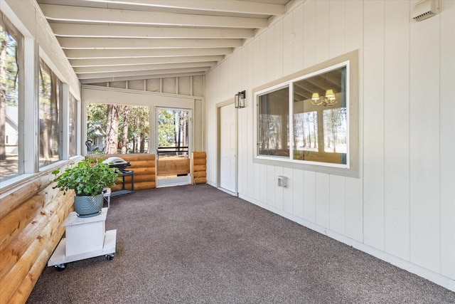 unfurnished sunroom with vaulted ceiling with beams