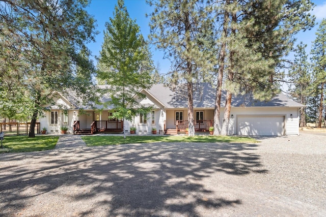 ranch-style home with a porch and a garage