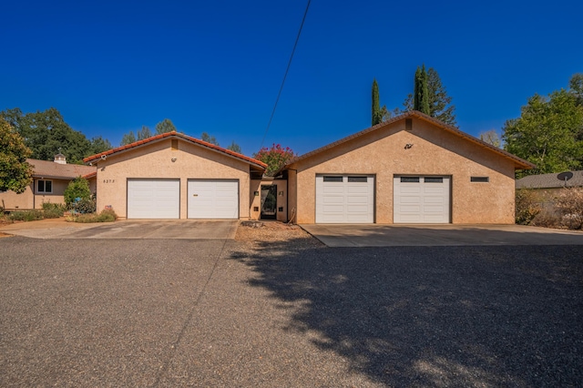 view of front of home featuring a garage and an outdoor structure