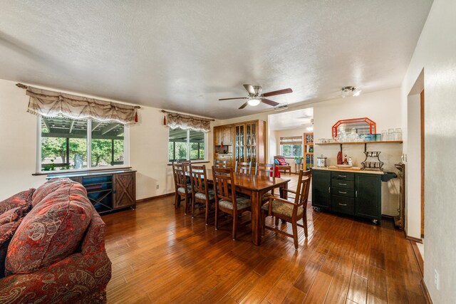 dining space featuring a textured ceiling, hardwood / wood-style floors, and ceiling fan