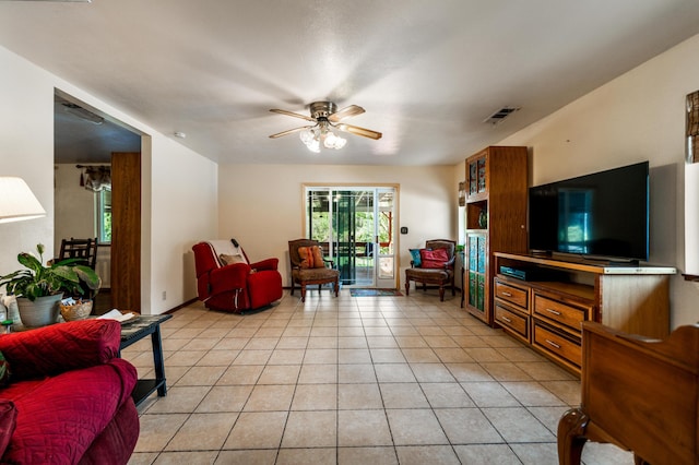 living room featuring light tile patterned floors, ceiling fan, and visible vents