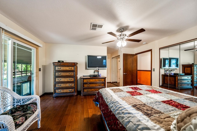 bedroom featuring a closet, ceiling fan, access to outside, dark hardwood / wood-style floors, and a textured ceiling