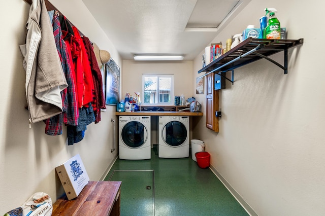 laundry room with laundry area, baseboards, and washer and dryer