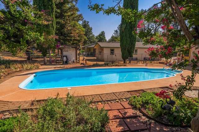 view of swimming pool with a fenced in pool, fence, and a patio