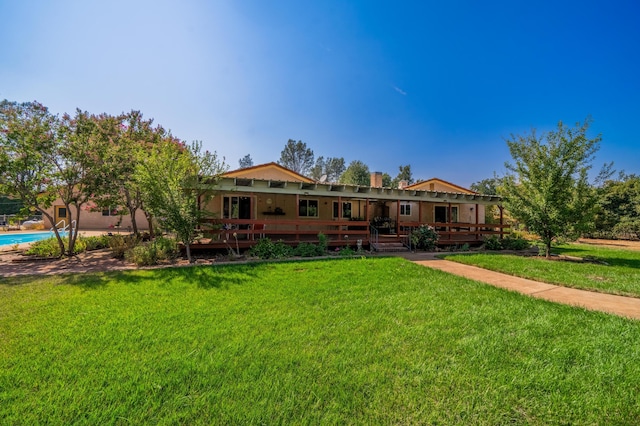 rear view of property with a yard