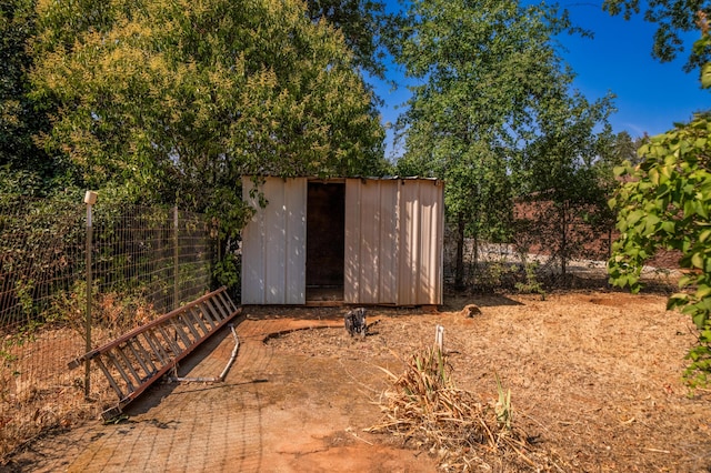 view of shed with fence