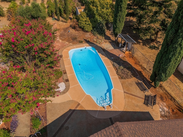 view of pool with a patio area and fence