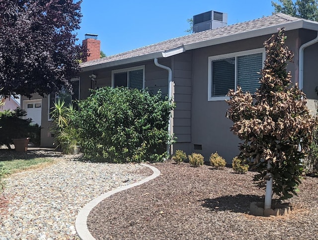 view of side of property featuring central AC