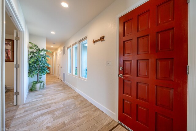 entryway with light wood-style floors, baseboards, and recessed lighting