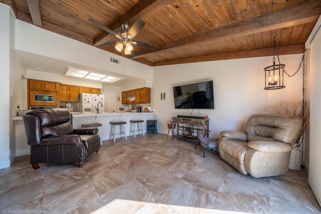 living area with ceiling fan with notable chandelier, wooden ceiling, visible vents, and vaulted ceiling with beams