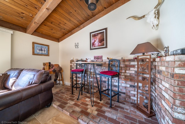 interior space with vaulted ceiling with beams, wooden ceiling, baseboards, and brick floor