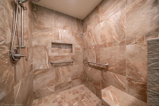 full bath featuring a tile shower