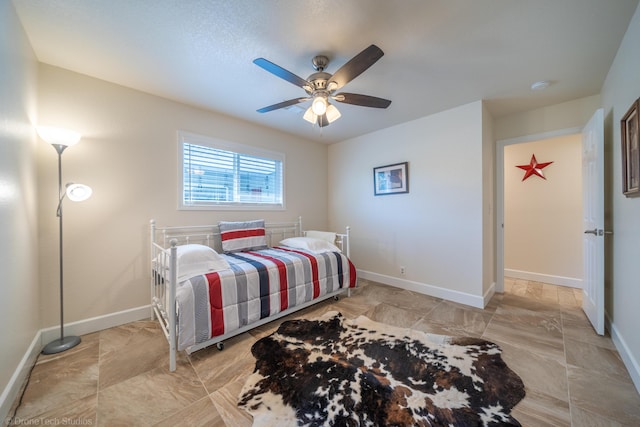 bedroom featuring a ceiling fan and baseboards