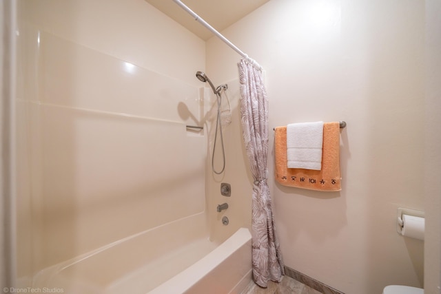 bathroom featuring shower / bathtub combination with curtain