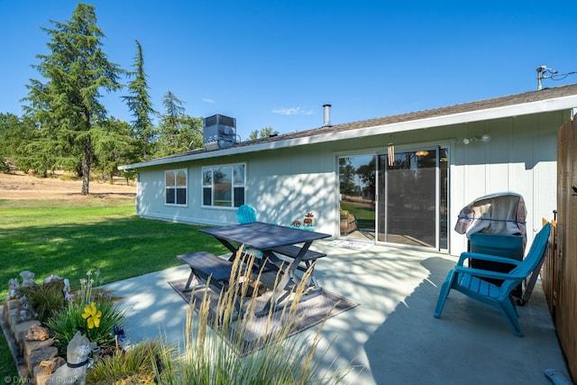 back of house with a patio area, a lawn, and central air condition unit