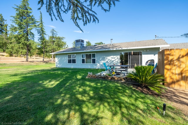 back of house featuring central AC, a yard, and a patio