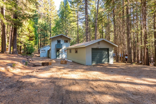 view of front facade featuring an outbuilding and a garage