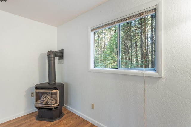 room details with hardwood / wood-style flooring and a wood stove