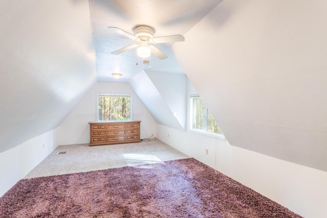 additional living space featuring ceiling fan, light colored carpet, and vaulted ceiling