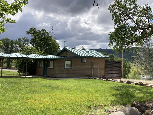 rear view of property featuring a yard