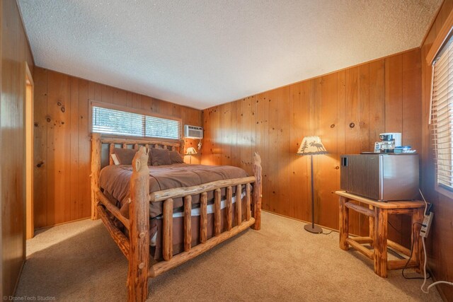 bedroom featuring a textured ceiling, a wall mounted air conditioner, light carpet, wood walls, and a closet