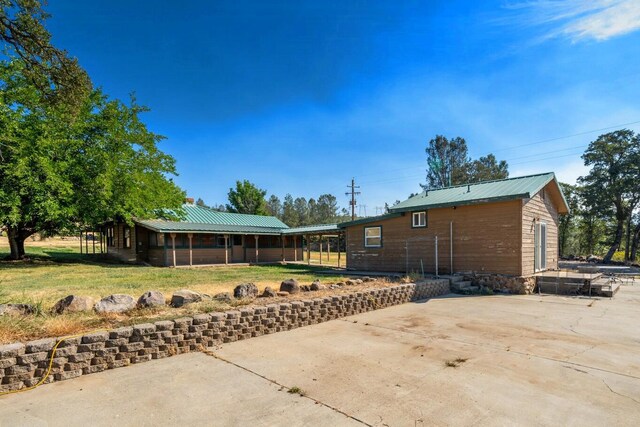 back of property with a yard and a patio area