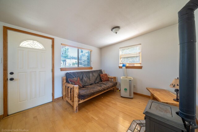 entryway featuring a wood stove and light hardwood / wood-style flooring