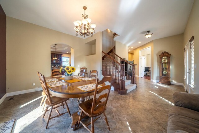 tiled dining area featuring an inviting chandelier