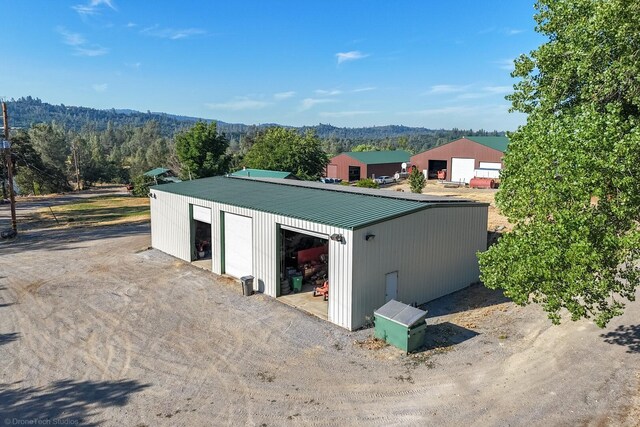 exterior space with a garage and an outbuilding