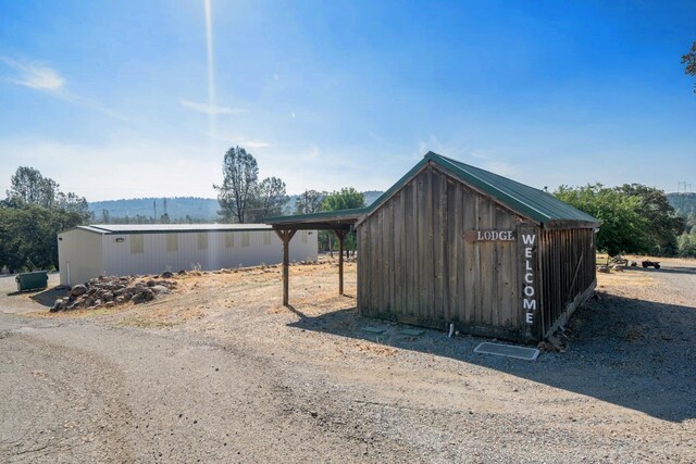 view of side of home with a shed