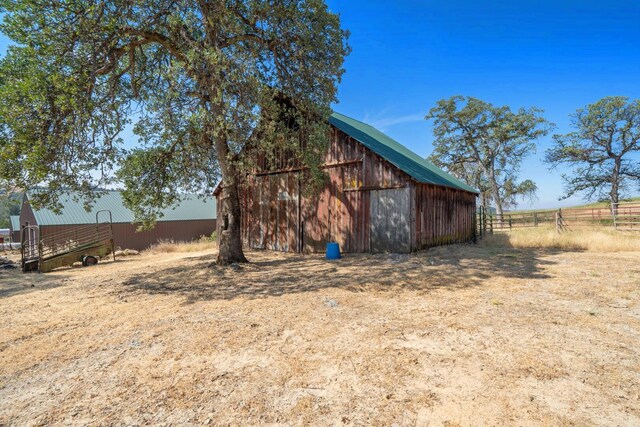 view of yard featuring a rural view and an outbuilding