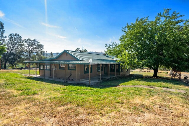 rear view of property with a lawn