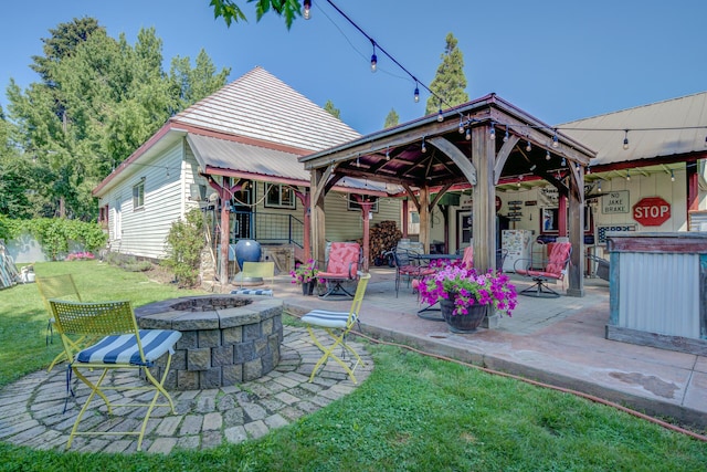 back of house featuring a patio, an outdoor fire pit, a gazebo, and a lawn