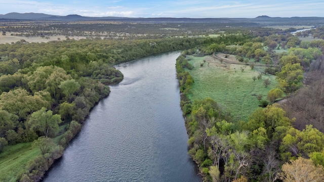 drone / aerial view featuring a water and mountain view