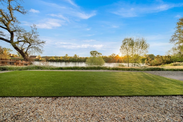 view of property's community featuring a yard and a water view