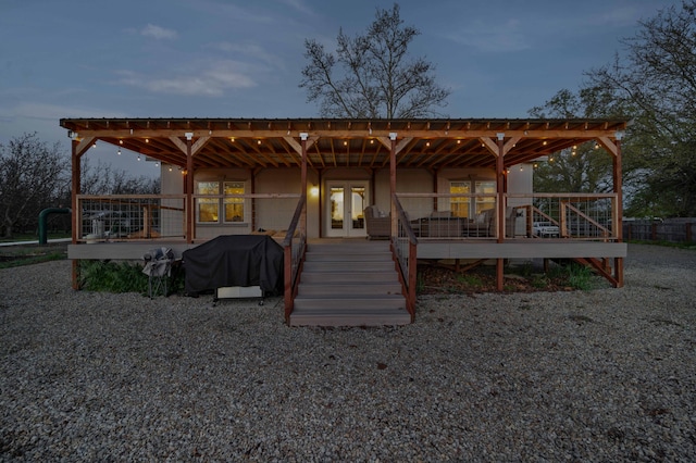 view of front facade with a deck and french doors